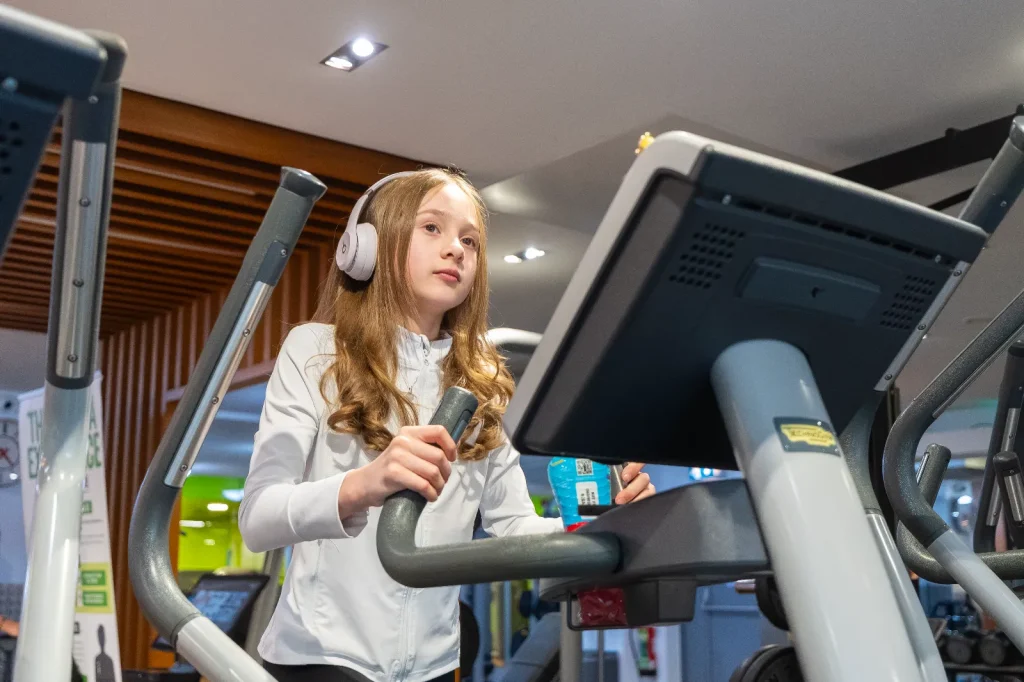 Young girl using a cross trainer in the junior gym at Belhus Park leisure centre