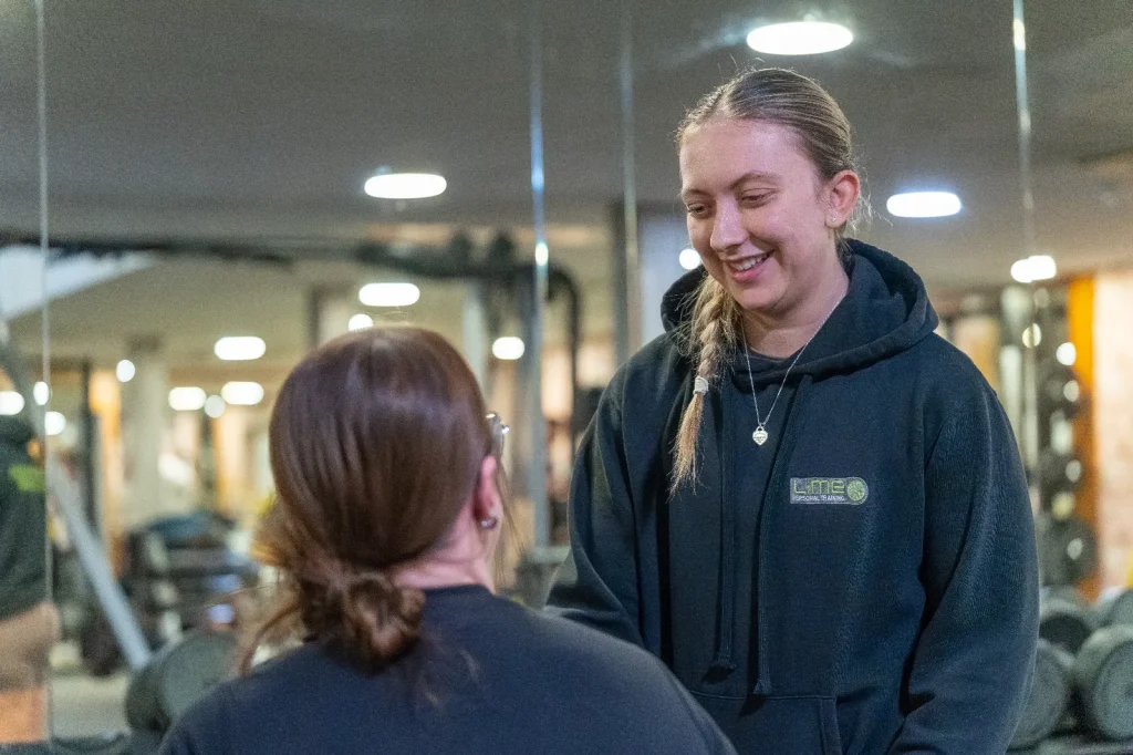 Lime personal trainer talking with a member at Corringham leisure centre gym