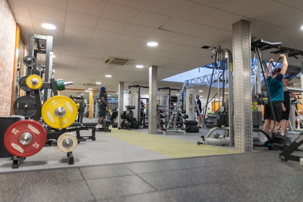 Well-equipped free weights area with barbells, weight plates and resistance machines at Corringham gym