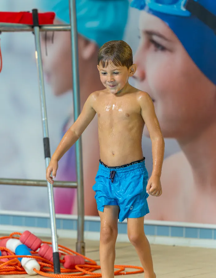 Young boy at poolside during a children's swimming lesson at an Impulse Leisure leisure centre