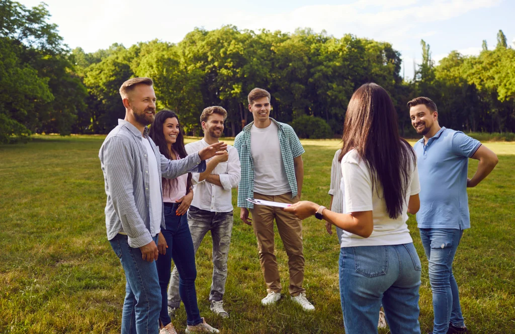 a group of men and women gathered in a circle for a team building activity